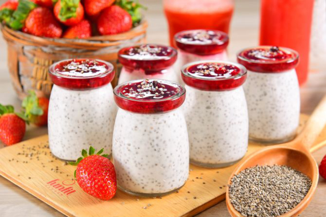 O vegano chia pudding leva sementes de chia hidratadas no leite de coco coberto com geleia de morango.