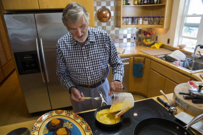 Graham Kerr, the "Galloping Gourmet" of television fame -- the cooking show ran from 1969 to 1971 -- mixes Egg Beaters and whole egg while preparing lunch at home in Mount Vernon, Wash., Aug. 26, 2016. In the 1970s, Kerr lurched from indulgence to asceticism and a denunciation of excess, including his own. Only gradually and with age, he said, did he find his way to a middle ground. (Ruth Fremson/The New York Times)