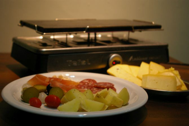 A casa serve o prato em pequenas frigideiras individuais, em que o próprio cliente derrete os queijos. Foto: Divulgação