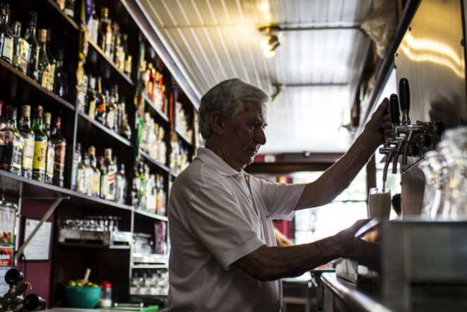 Dino Chiumento, 83 anos, trabalha desde os 14 anos no Bar Stuart, na praça Osório. O bar completou 114 anos e teve em sua história clientes dos mais variados meios, de jornalistas à políticos passando por artistas como Paulo Leminski. Foto: Brunno Covello/Arquivo Gazeta do Povo