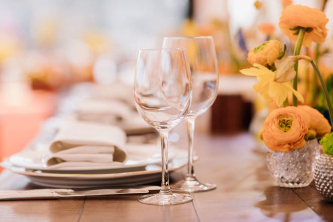 Served dinner table in a restaurant. Restaurant interior. Cozy restaurant table setting. Defocused background