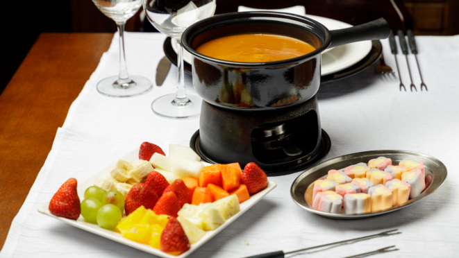 Fondue de doce de leite Argentino, sem glúten, acompanhado de sete tipos de frutas e marshmallow, do Petit Château. 