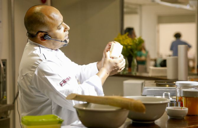 O chef Washington Silveira, professor do Centro Europeu, ensinando a fazer um espetinho de camarão que é espetado na cana de açúcar. Foto: Hugo Harada/Gazeta do Povo