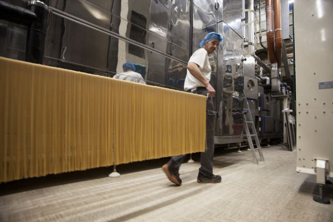 Workers prepare Monograno Spaghettoni pasta at the Pastificio Felicetti factory, which began using only Italian-grown wheat in 2013, in Predazzo, Italy, Dec. 23, 2016. The company's decision to use durum wheat grown exclusively in Italy is paying off in flavor and sales, capitalizing on growing interest in expressions of terroir and feeding Italian pride at a time in which the country could use it. (Cristiano Bendinelli/The New York Times)
