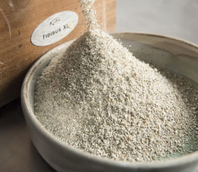 Kevin Adey, the chef at Faro, mills rye flour from whole grains, for pasta and bread, in New York, Dec. 29, 2016. Riding a wave of interest in ancient grains, rye has recently been sprouting in many influential kitchens — in pasta, porridge, brownies and bread. (Evan Sung/The New York Times)