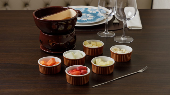 Fondue de chocolate ao leite ou fondue toffee acompanhado de seis frutas da estação, sobremesa servida no jantar do Château de Gazon.