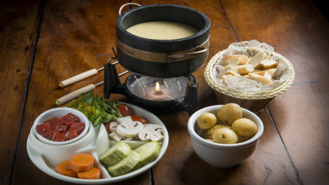 Fondue de queijo, acompanhado de batatinhas, legumes, goiabada e pães. Opção de entrada servida no jantar no Le Réchaud.