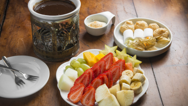 Le Rechaud serve um fondue de chocolate com frutas, carolinas e marshmallow.