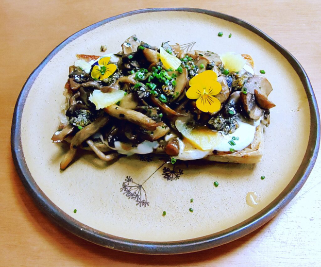 <em>Ouro da terra</em>, composto de ciabatta tostada, alho e alecrim, mix de cogumelos salteados na manteiga, creme de ricota trufado, supreme de laranja, crocante de gergelim caramelizado e molho tarê. | Foto: Anacreon de Téos