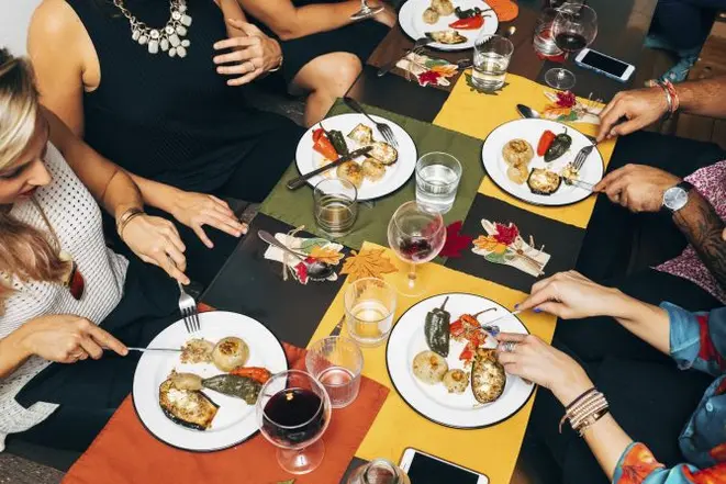 There are now several apps that allow people to organize and attend dinner parties with strangers as they seek their "urban tribe." (Andrew White/The New York Times)