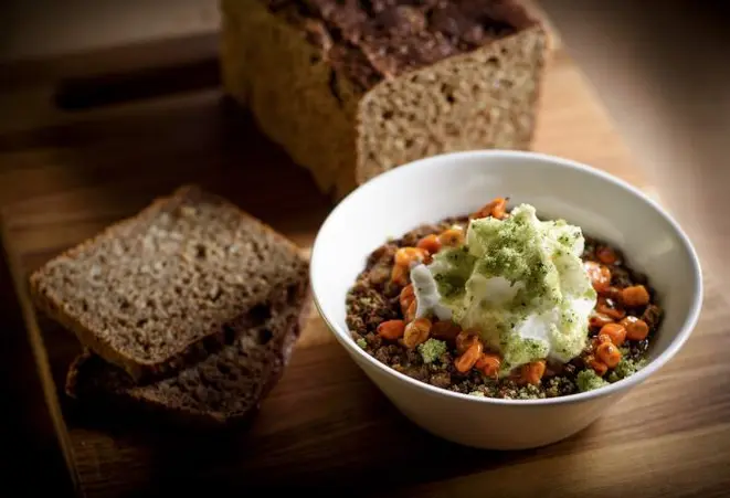 Rye bread and cold rye bread porridge with vanilla foam, sea buckthorn, tarragon sugar and caramelized rye from Meyers Bageri, in New York, Jan. 3, 2017. Riding a wave of interest in ancient grains, rye has recently been sprouting in many influential kitchens — in pasta, porridge, brownies and bread. (Francesco Sapienza/The New York Times)
