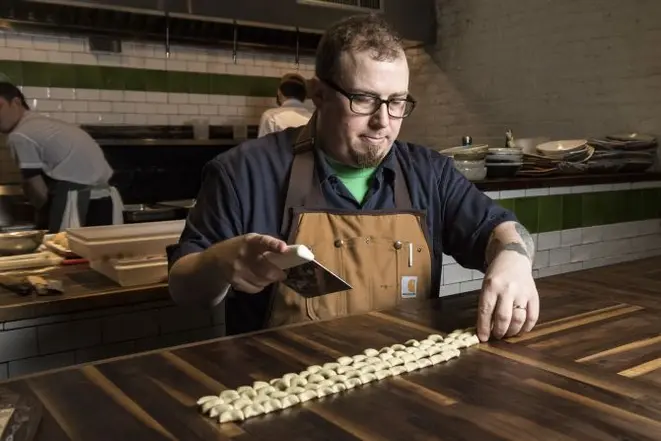 Kevin Adey, the chef at Faro, makes a dish of rye strascinati with venison ragu and celery root, in New York, Dec. 29, 2016. Riding a wave of interest in ancient grains, rye has recently been sprouting in many influential kitchens — in pasta, porridge, brownies and bread. (Evan Sung/The New York Times)