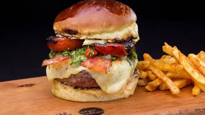 Fuching Chimi Burger, do Wolfsburger: Burger de 180g grelhado na brasa, pão brioche, queijo provolone, bacon, chimichurri da casa, tomate assado e maionese da casa.